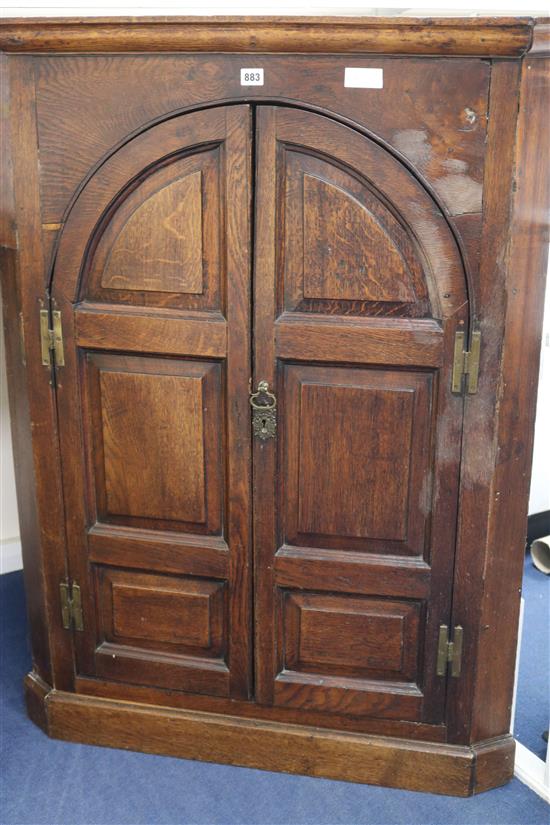 A late 18th century panelled oak corner cupboard, 121cm high